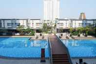 Swimming Pool Bright 1BR with City View Apartment at Cosmo Mansion By Travelio
