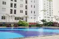 Swimming Pool Simply 1BR with Sofa Bed at Bassura City Apartment By Travelio