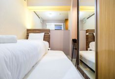 Bedroom 2 Classic and Comfy 2BR Bassura City Apartment By Travelio
