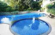 Swimming Pool 6 Clean and Lavish Design 1BR Dago Suites Apartment By Travelio