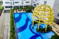 Swimming Pool Modern and Comfy 2BR Bassura City Apartment By Travelio