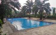 Swimming Pool 3 Relaxing and Pleasant 2BR with Pool View Mutiara Bekasi Apartment By Travelio