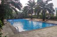 Swimming Pool Relaxing and Pleasant 2BR with Pool View Mutiara Bekasi Apartment By Travelio