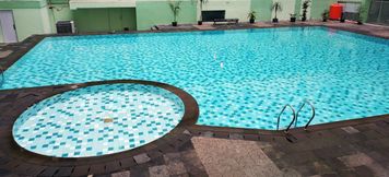 Swimming Pool 3 Warm and Comfortable 1BR Menteng Square Apartment By Travelio