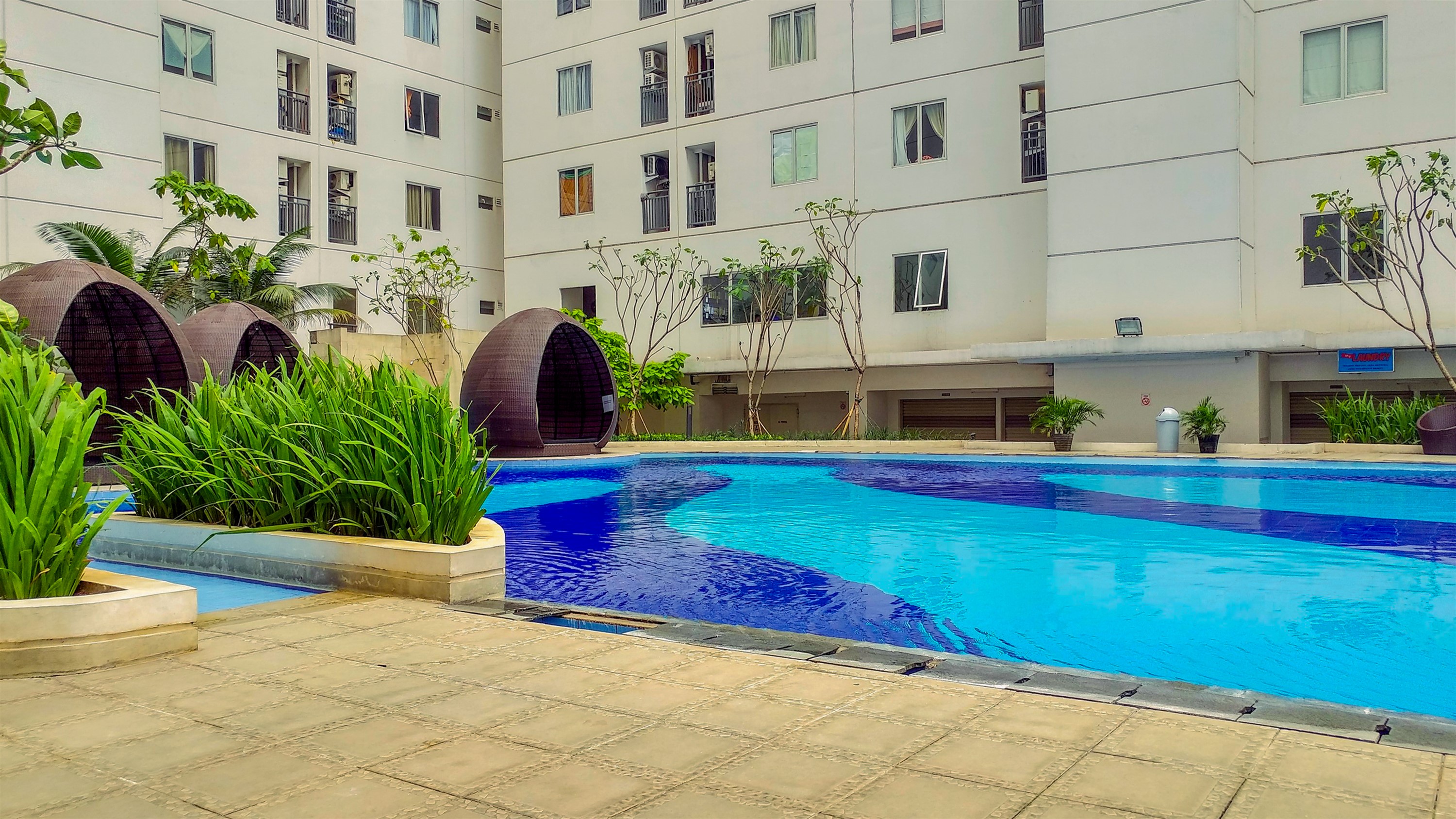 Swimming Pool 4 Mall View 2BR at Bassura City Apartment By Travelio