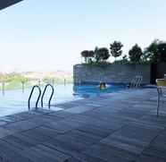 Swimming Pool 4 Minimalist Style 2BR at Tamansari Papilio Apartment By Travelio