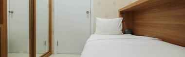 Bedroom 2 Near Shopping Mall 2BR at Green Pramuka City Apartment By Travelio