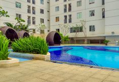 Swimming Pool 3 Modern Living 2BR with City View at Bassura Apartment By Travelio
