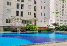 Swimming Pool 4 Modern Living 2BR with City View at Bassura Apartment By Travelio