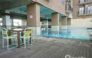 Swimming Pool 3 Comfy Living Studio Apartment at Tamansari Panoramic By Travelio