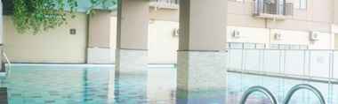 Swimming Pool 2 Comfy Living Studio Apartment at Tamansari Panoramic By Travelio