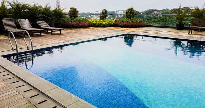 Swimming Pool Tidy and Clean Studio Room at Tree Park Apartment By Travelio