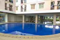 Swimming Pool Minimalist 2BR at Green Park View Apartment By Travelio