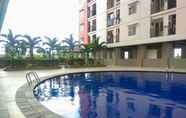 Swimming Pool 5 Minimalist 2BR at Green Park View Apartment By Travelio