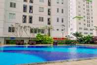 Kolam Renang Minimalist Design 2BR Apartment at Bassura City near Shopping Mall By Travelio
