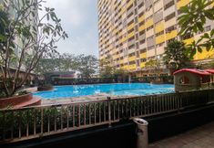 Swimming Pool 4 Cozy 2BR Apartment at Sentra Timur Residence Apartment By Travelio