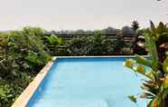 Swimming Pool 4 Cozy 2BR Apartment with Garden View at Tuscany Residences By Travelio