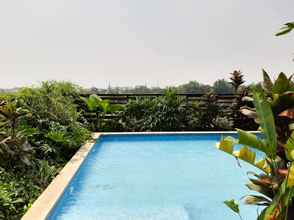 Swimming Pool 4 Cozy 2BR Apartment with Garden View at Tuscany Residences By Travelio