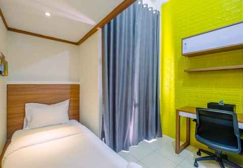 Bedroom Cozy Living Studio at Dave Apartment near UI By Travelio