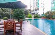 Swimming Pool 4 Cozy 2BR Apartment at Woodland Park Residence By Travelio