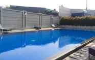 Swimming Pool 5 Simply and Cozy Living 1BR at Tifolia Apartment By Travelio