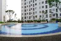 Swimming Pool Fully Furnished & Comfortable 2BR Bassura City Apartment By Travelio