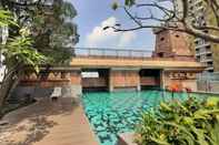 Swimming Pool Spacey 2BR at Great Western Resort Apartment By Travelio
