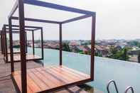 Swimming Pool Fully Furnished with Comfy Design Studio at Grand Kamala Lagoon Apartment By Travelio