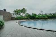 Swimming Pool Simply and Cozy 1BR Apartment at Pejaten Park Residence By Travelio