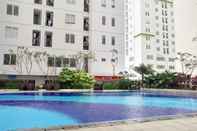Swimming Pool Comfort and Nice 2BR at Bassura City Apartment By Travelio