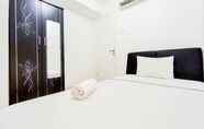 Bedroom 2 Scenic 2BR Apartment with City View at Bassura City By Travelio