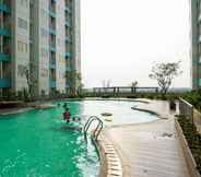 Swimming Pool 4 Cozy and Minimalist 2BR Apartment at The Nest near Puri By Travelio