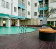 Swimming Pool 5 Enjoy Living Studio at The Nest Puri Apartment By Travelio