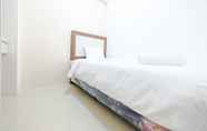 Bedroom 2 Clean & New 2BR Bassura City Apartment By Travelio