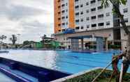 Swimming Pool 6 2BR Nice and Fancy Apartment at Green Pramuka City By Travelio