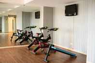 Fitness Center Warm and Nice 1BR Apartment at Belmont Residence Puri By Travelio