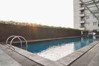 Swimming Pool Warm and Nice 1BR Apartment at Belmont Residence Puri By Travelio