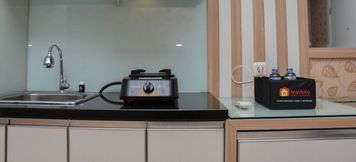Common Space 3 Comfort Living 1BR Apartment at Green Pramuka City By Travelio