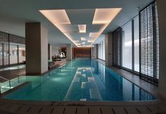 Swimming Pool 7 Comfy and Spacious 1BR Apartment with Motorized Standing Desk at Branz BSD City By Travelio