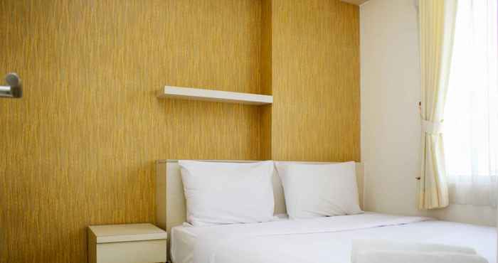 Bedroom Warm and Minimalist 2BR Bassura City Apartment By Travelio