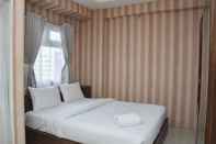 Bedroom Comfort and Cozy Living Studio at Green Pramuka City Apartment By Travelio