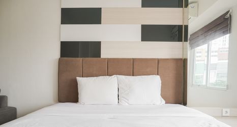 Bedroom 2 Minimalist and Comfort Living 1BR at Bassura City Apartment By Travelio