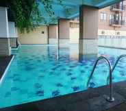 Swimming Pool 7 Bright 2BR Apartment at Tamansari Panoramic By Travelio