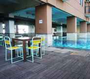 Swimming Pool 6 Bright 2BR Apartment at Tamansari Panoramic By Travelio