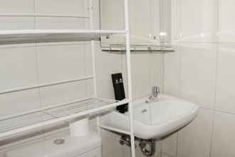 In-room Bathroom 4 Comfort and Minimalist 2BR at Springlake Summarecon Bekasi Apartment By Travelio