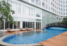 Swimming Pool 3 Serene Exclusive Modern Studio at Grand Sungkono Lagoon Apartment By Travelio