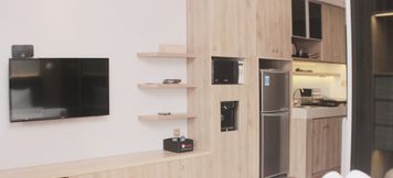 Common Space 4 Cozy and Minimalist Studio at Vasanta Innopark Apartment By Travelio