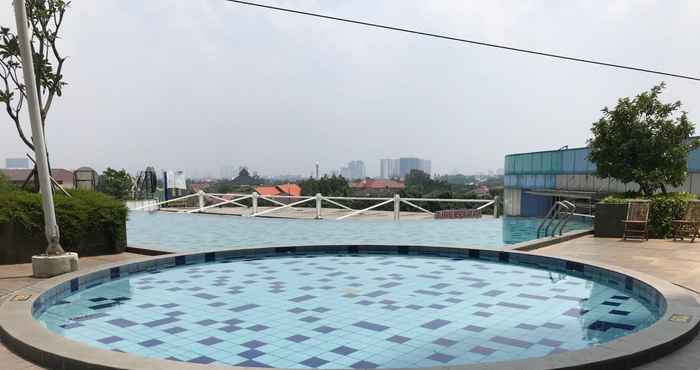 Swimming Pool Cozy and Warm Studio at Cinere Bellevue Suites Apartment By Travelio