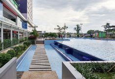 Swimming Pool 6 Modern Look 2BR Apartment Green Pramuka City near Mall By Travelio
