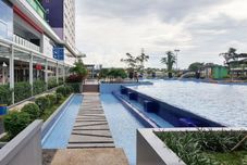 Swimming Pool Modern Look 2BR Apartment Green Pramuka City near Mall By Travelio